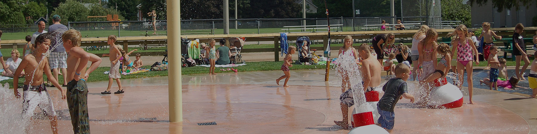 kids playing at a splash pad in acton on a sunny day